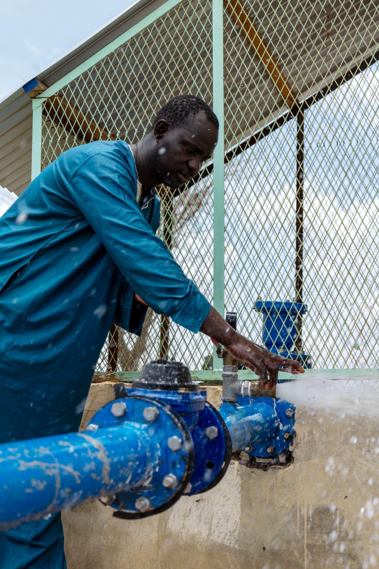 An operator opening an irrigation water valve